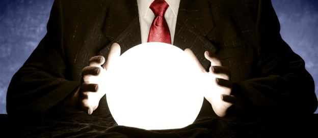 Person in suit holding glowing crystal ball