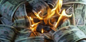 US dollar bills burning in bright flames